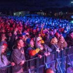 concert goers behind a security barrier 2048x969 1